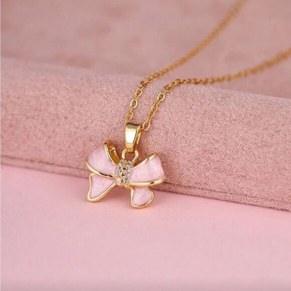 Anthropologie Jewelry - Gold Necklace with Pink Bow Pendant Q541